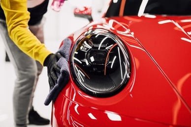 Microfiber Car Cleaning Cloths & Towels 2 Person meticulously cleaning a car with a high-quality Microshine microfiber cloth, highlighting professional car detailing
